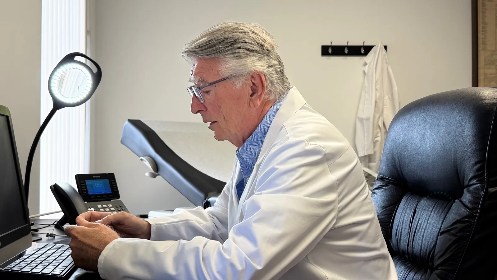Dr. Carroll at his desk computer in the Maitland office
