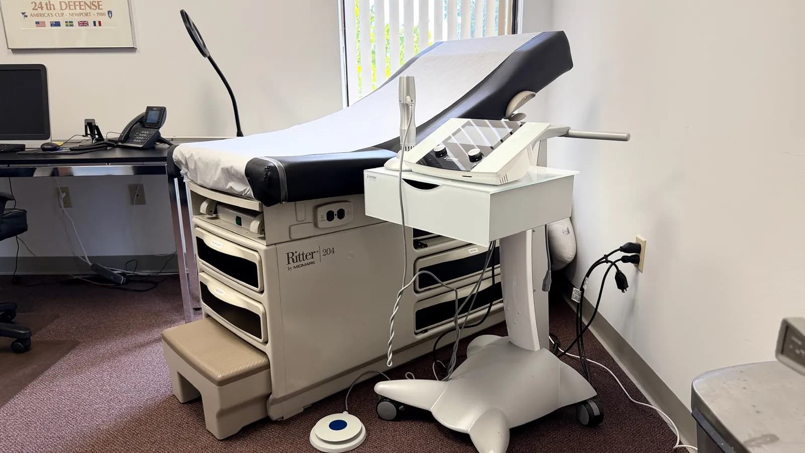 A treatment room at the Maitland office: an exam table with the shockwave unit beside it